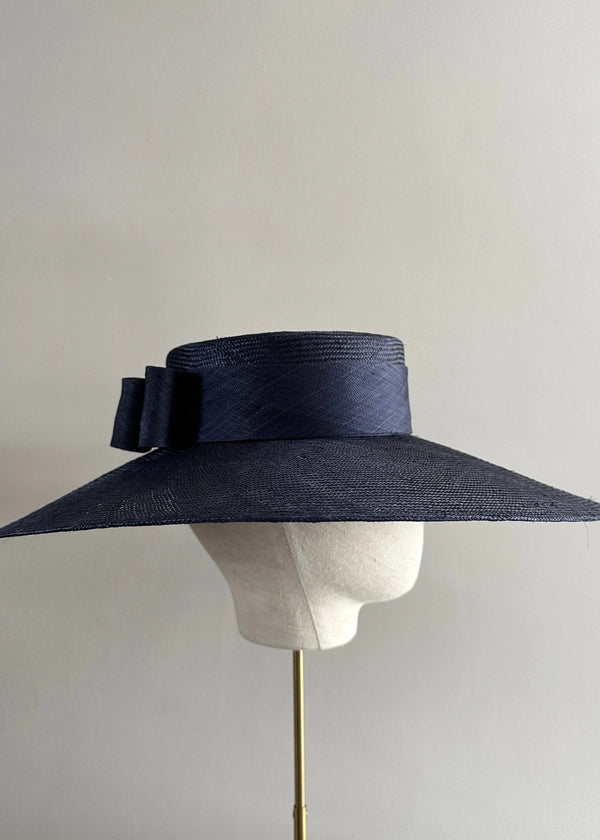 Enid Boater in Straw with Pinokpok Bow in Navy Jane Taylor London
