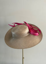 Sculptural Straw hat with Pink Accent.