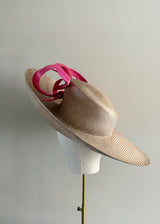 Sculptural Straw hat with Pink Accent.