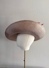 Sculptural Straw hat with Pink Accent.