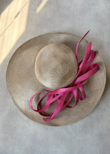 Sculptural Straw hat with Pink Accent.