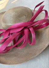 Sculptural Straw hat with Pink Accent.